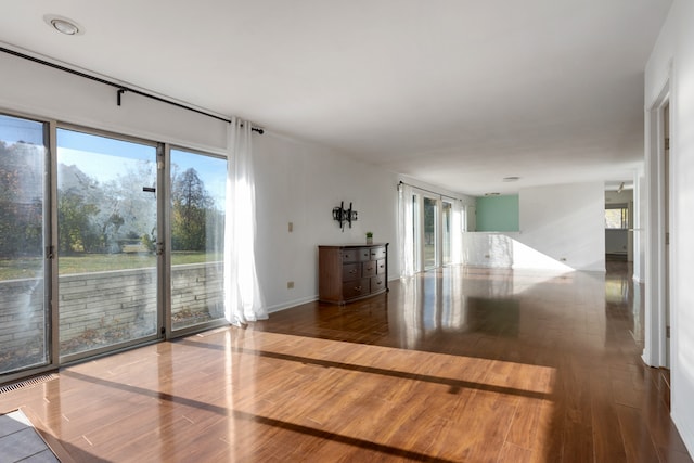 unfurnished room featuring hardwood / wood-style flooring