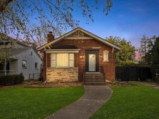 bungalow-style house with a lawn