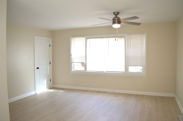 spare room featuring light hardwood / wood-style floors and ceiling fan