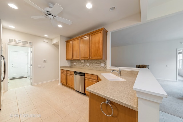 kitchen featuring sink, kitchen peninsula, tasteful backsplash, ceiling fan, and stainless steel dishwasher