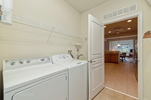 washroom featuring light tile patterned floors and separate washer and dryer