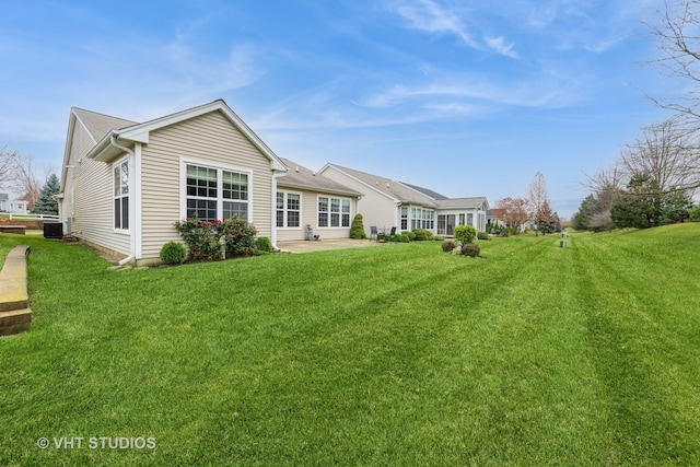 rear view of house with a patio, a lawn, and cooling unit