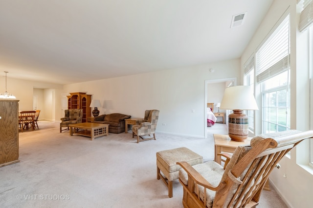 living area featuring light carpet