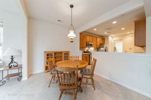 dining area with light tile patterned floors and ceiling fan