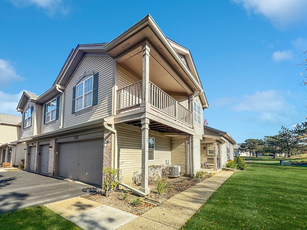 view of home's exterior with central air condition unit, a lawn, and a garage