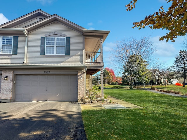 view of front of property with a front yard and a garage