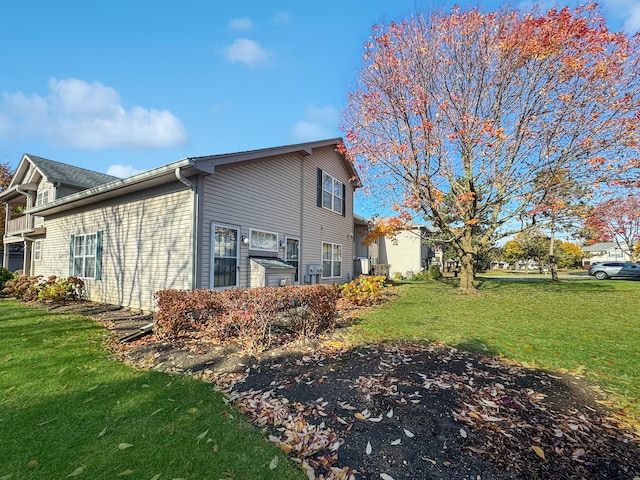 view of side of property with a lawn