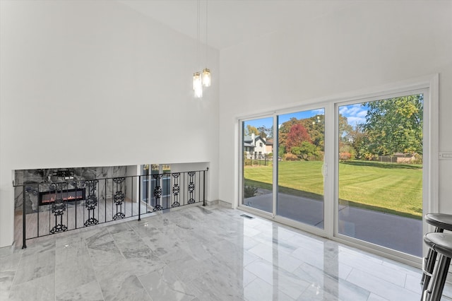 unfurnished living room with a towering ceiling