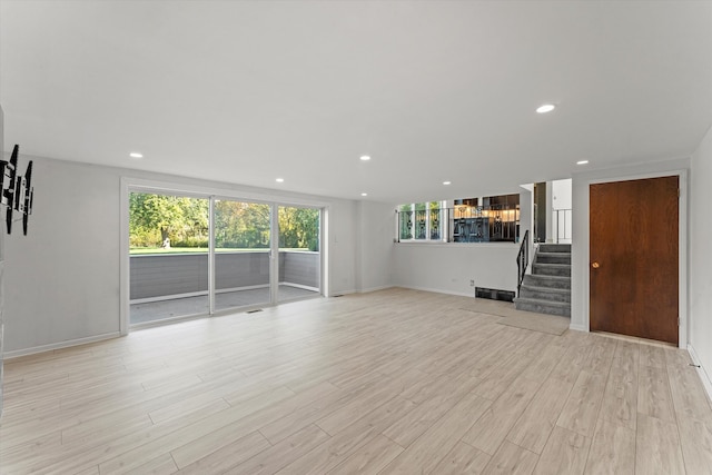 unfurnished living room featuring light hardwood / wood-style flooring and a wealth of natural light