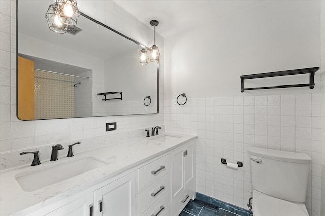 bathroom with toilet, curtained shower, vanity, and tile walls