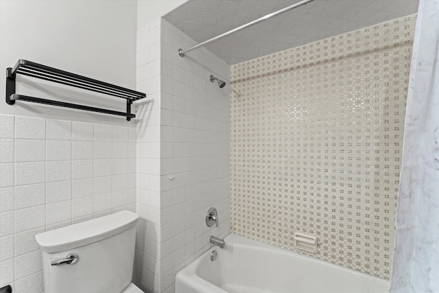 bathroom with toilet, shower / bathtub combination with curtain, and tile walls