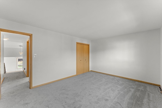 unfurnished room with light colored carpet