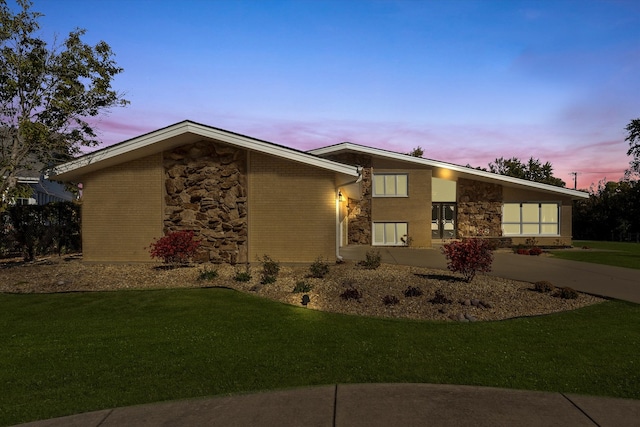 ranch-style house with a lawn