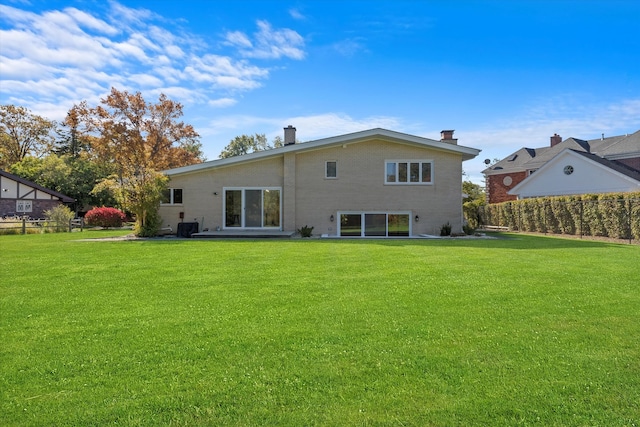 back of house with a lawn