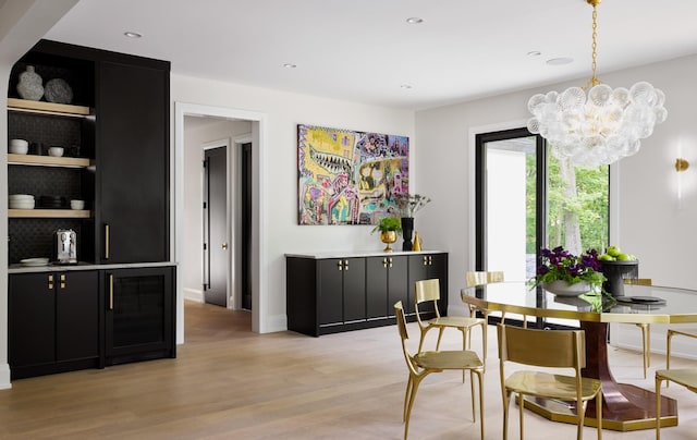 dining area featuring a chandelier and light hardwood / wood-style floors