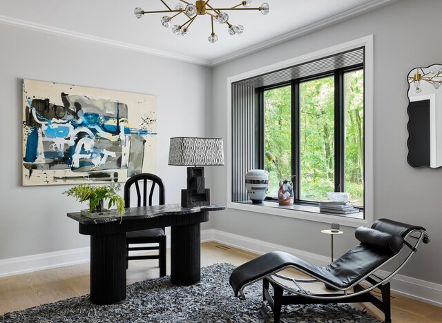 office with crown molding, plenty of natural light, an inviting chandelier, and hardwood / wood-style flooring