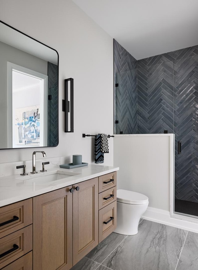 bathroom with vanity, toilet, and a shower with shower door