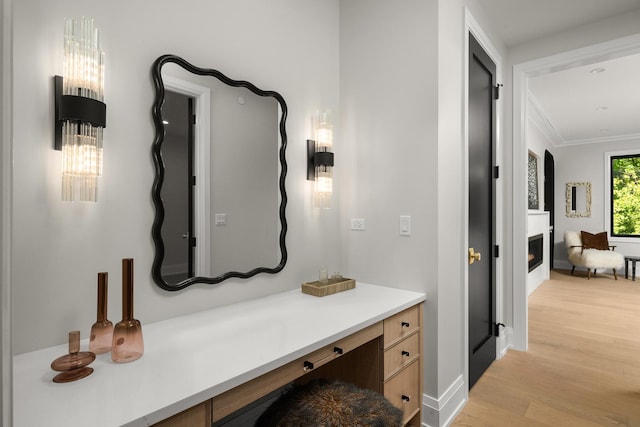 bathroom with hardwood / wood-style floors, vanity, and crown molding