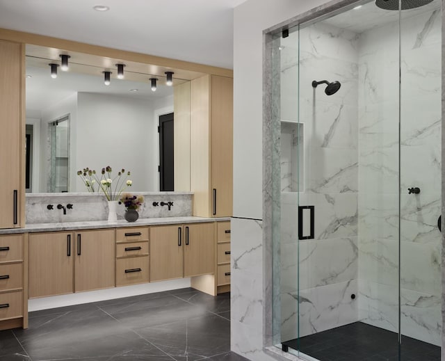 bathroom with decorative backsplash, a shower with shower door, and vanity