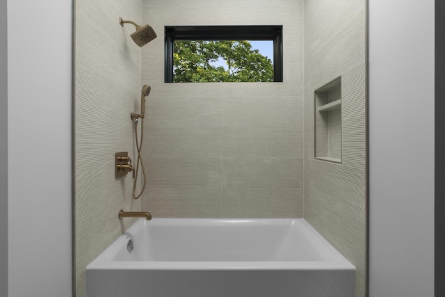 bathroom with tiled shower / bath combo