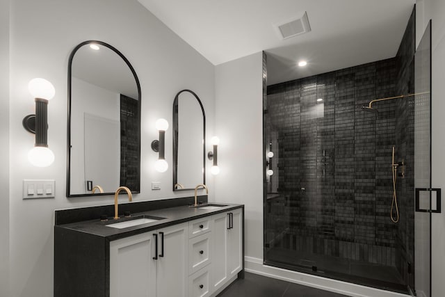 bathroom featuring tile patterned floors, vanity, and walk in shower