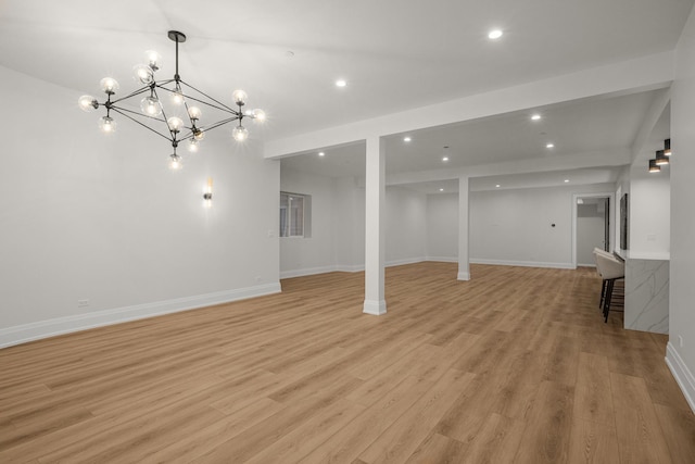 basement featuring a chandelier and light wood-type flooring