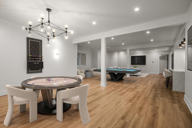 game room with light hardwood / wood-style floors, pool table, and a chandelier