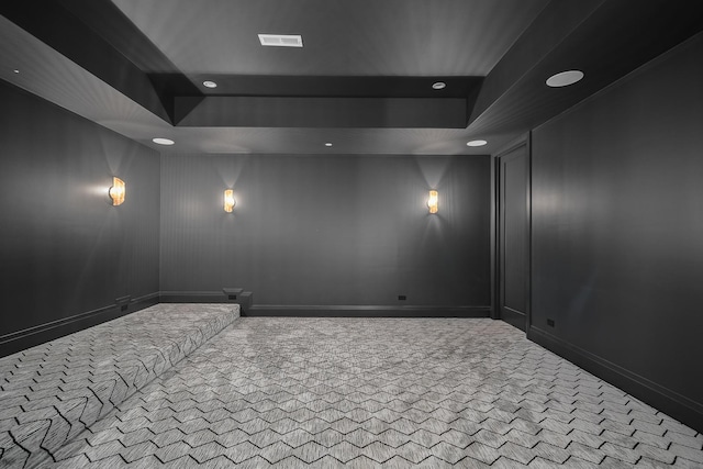 carpeted cinema with a tray ceiling