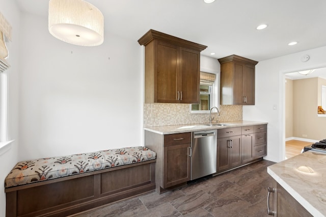 kitchen featuring decorative backsplash, sink, stainless steel dishwasher, range with gas stovetop, and dark brown cabinets