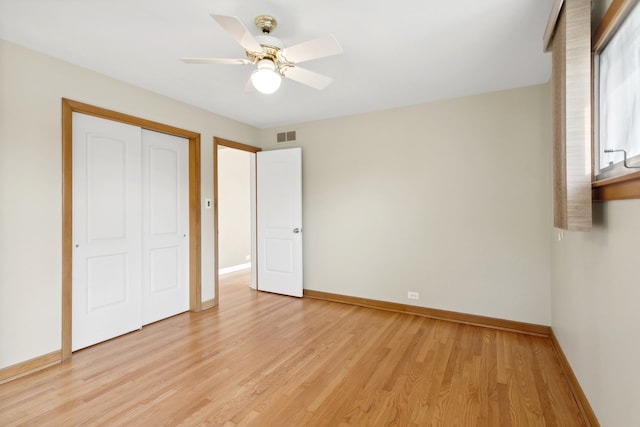 unfurnished bedroom with ceiling fan, a closet, and light wood-type flooring