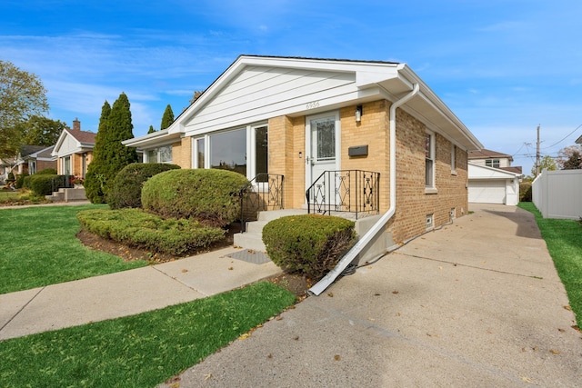 view of front of house with a garage and a front lawn