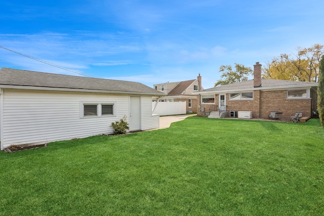 rear view of house featuring a patio and a lawn