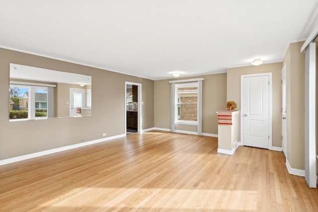 unfurnished room featuring light hardwood / wood-style flooring and crown molding