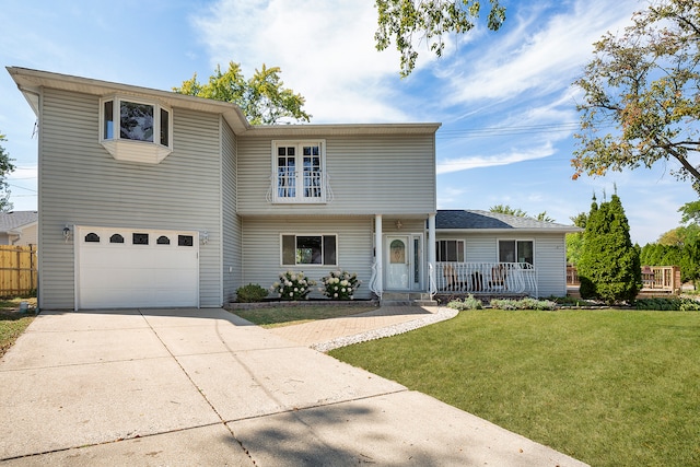 view of front property featuring a front yard, a porch, and a garage