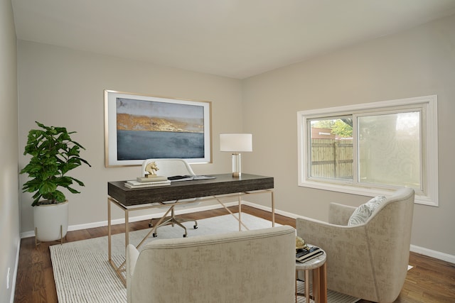 home office with dark hardwood / wood-style flooring