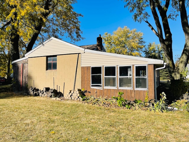 view of side of home featuring a lawn