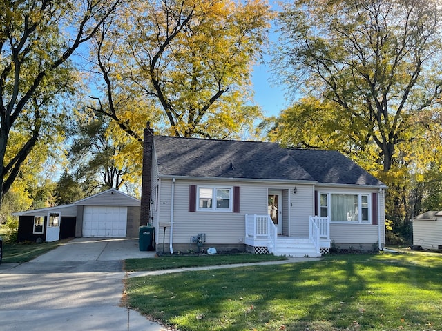 view of front of property featuring an outdoor structure, a garage, and a front lawn