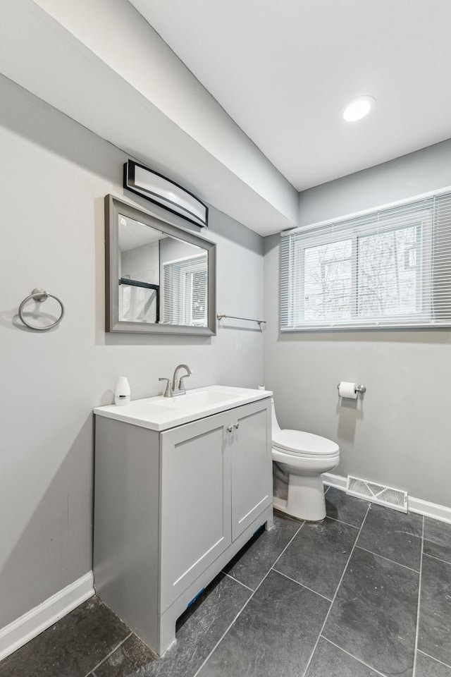 bathroom with vanity and toilet