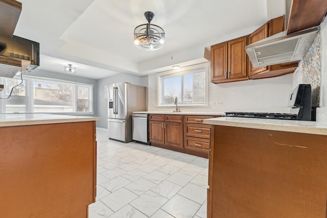 kitchen with pendant lighting, sink, plenty of natural light, and stainless steel appliances