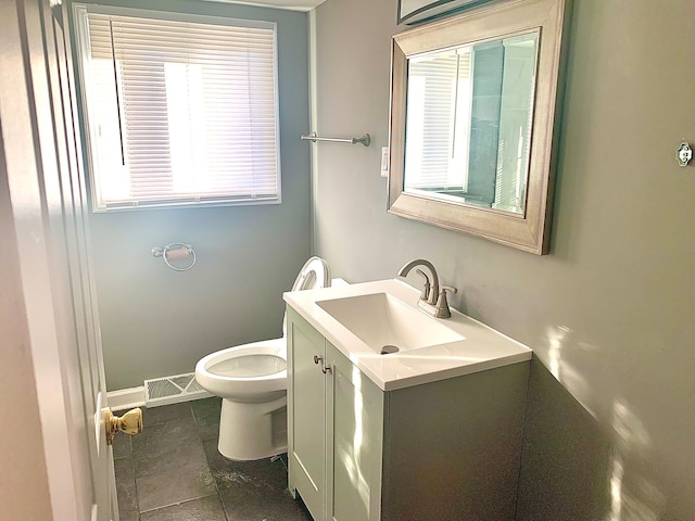 bathroom with vanity, toilet, and tile patterned flooring