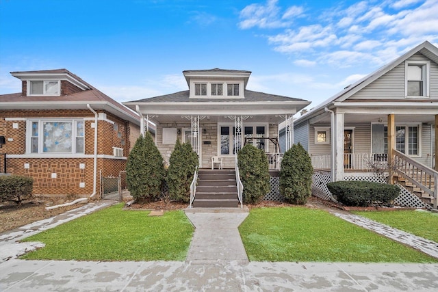 bungalow-style house featuring covered porch and a front lawn