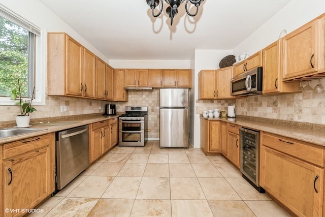 kitchen with tasteful backsplash, stainless steel appliances, beverage cooler, and light tile patterned floors