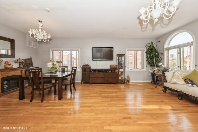 dining area featuring an inviting chandelier and light hardwood / wood-style flooring