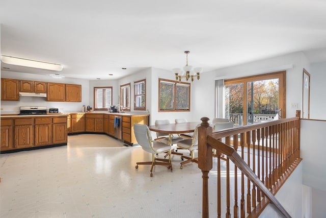 kitchen featuring black stove, stainless steel dishwasher, decorative light fixtures, and an inviting chandelier