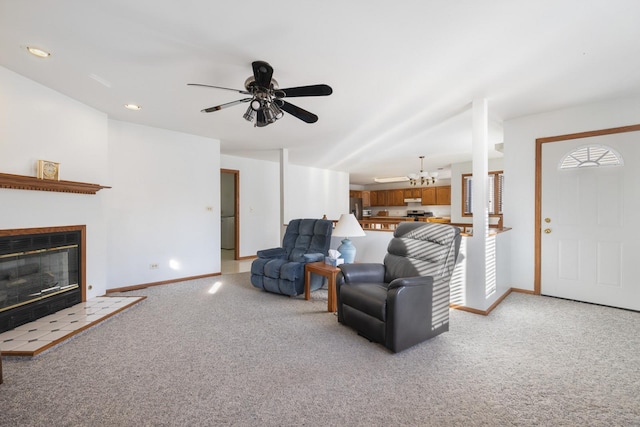 living room featuring light carpet, a tile fireplace, and ceiling fan