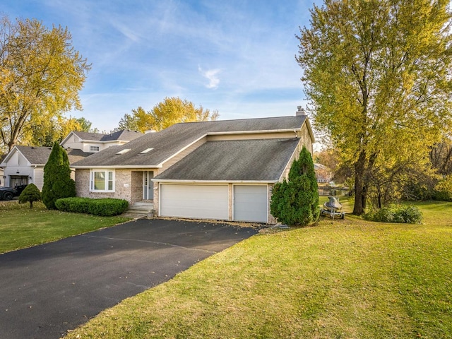 view of front of home with a front yard and a garage