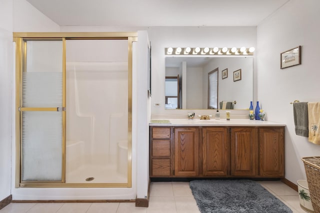 bathroom featuring a shower with door, tile patterned floors, and vanity