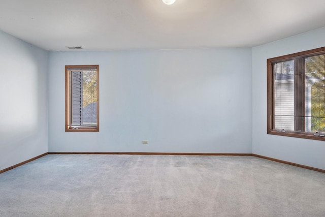 unfurnished room featuring light colored carpet