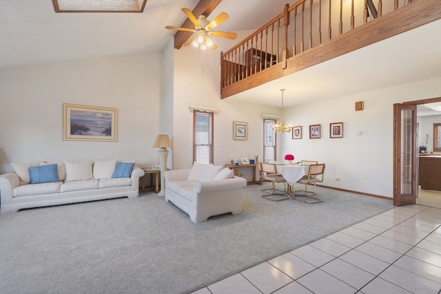 carpeted living room featuring ceiling fan and high vaulted ceiling