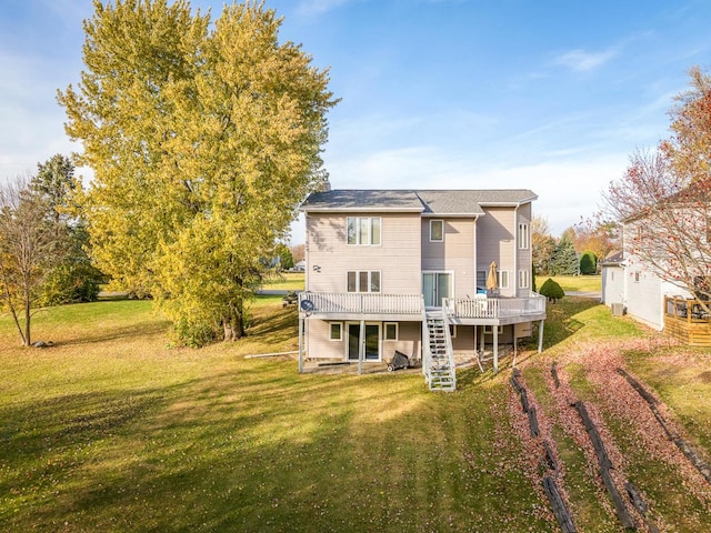 back of house with a wooden deck and a lawn